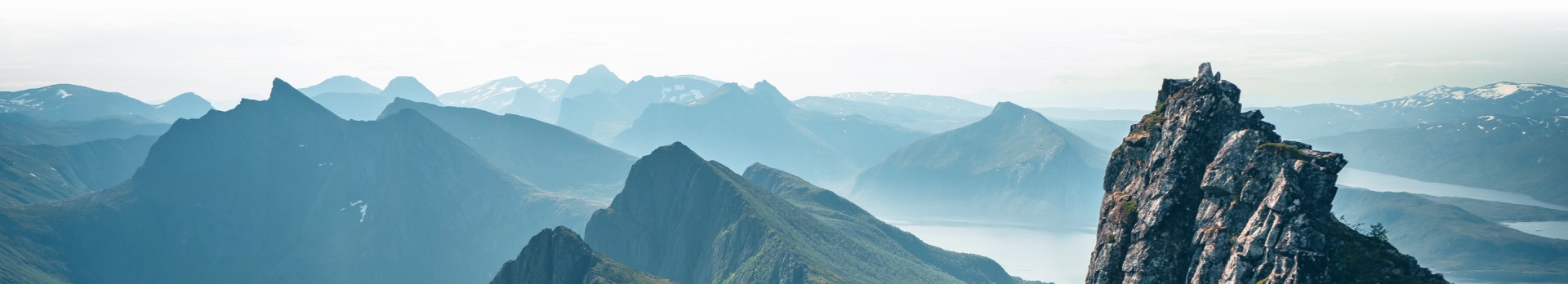 Wide mountain landscape at dusk, peaks and valleys in muted earth tones